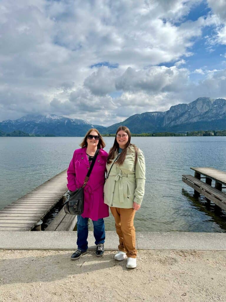 Amanda and Mom in trench coats near a lake